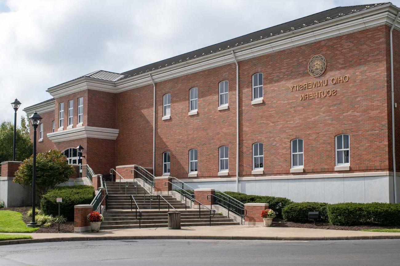 Southern campus library building exterior with a student walking up the stairs